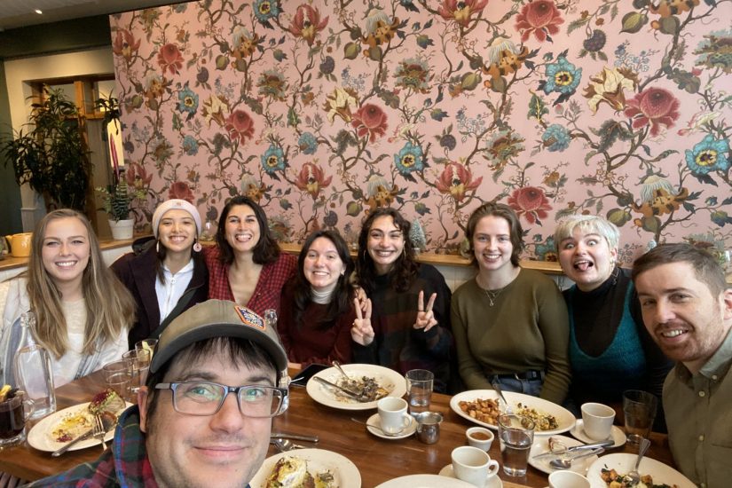 the full capstone group for the authors' (Chase and Nicolette) capstone project eating brunch together in a booth.