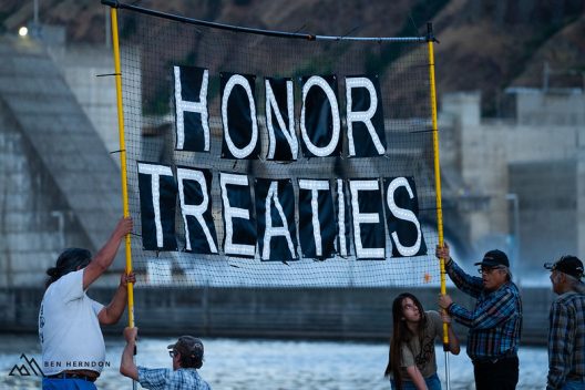 People holding a banner that reads "Honor Treaties"