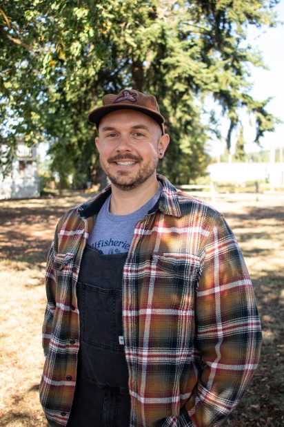 A headshot photo of Erick outside with a tree in the background