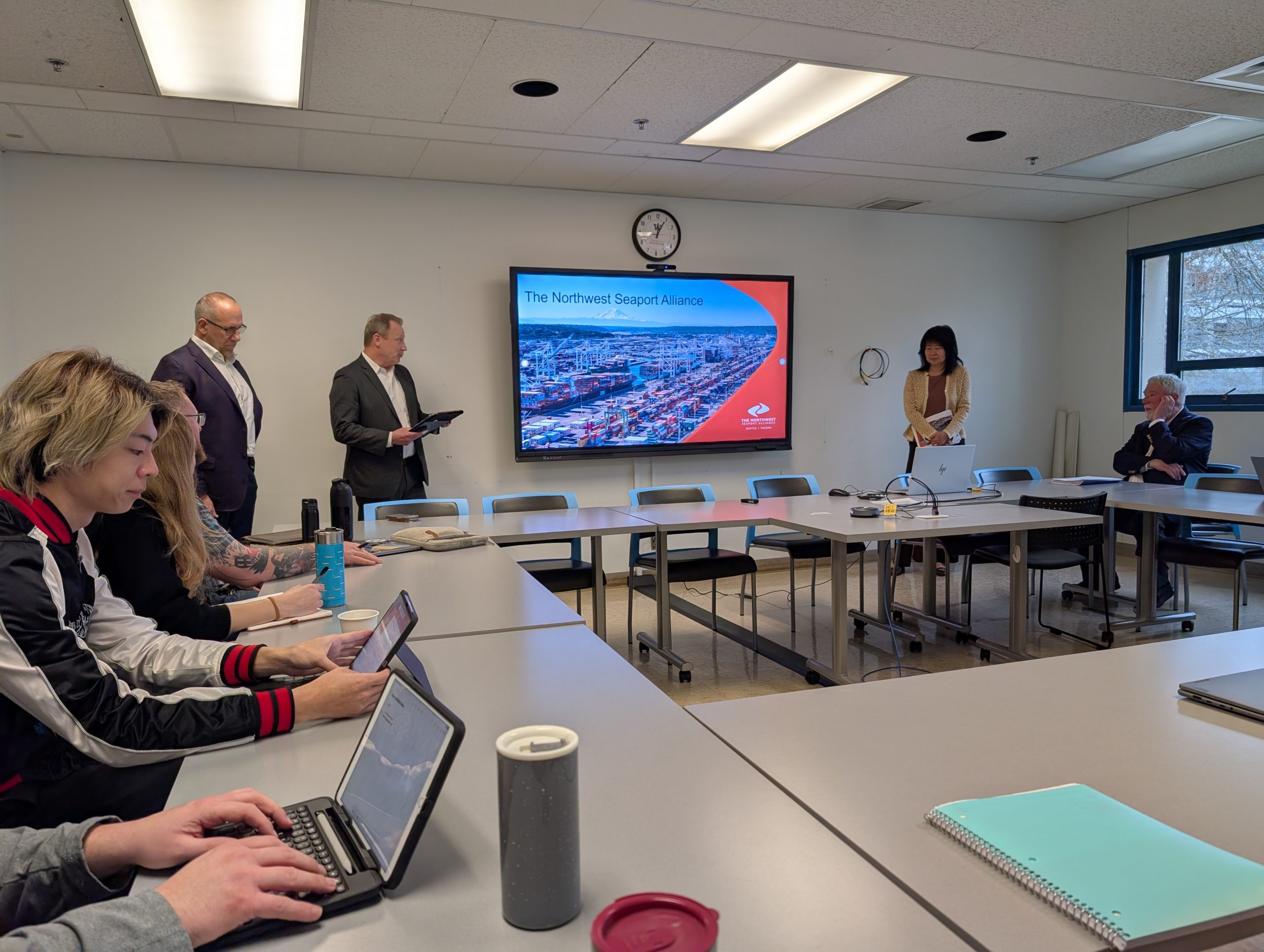 A meeting room with a presentation slide titled 